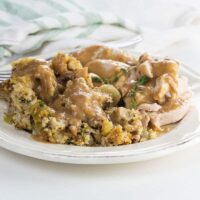 vegetarian cornbread stuffing (adapted from the silver palate) on a plate with turkey and gravy