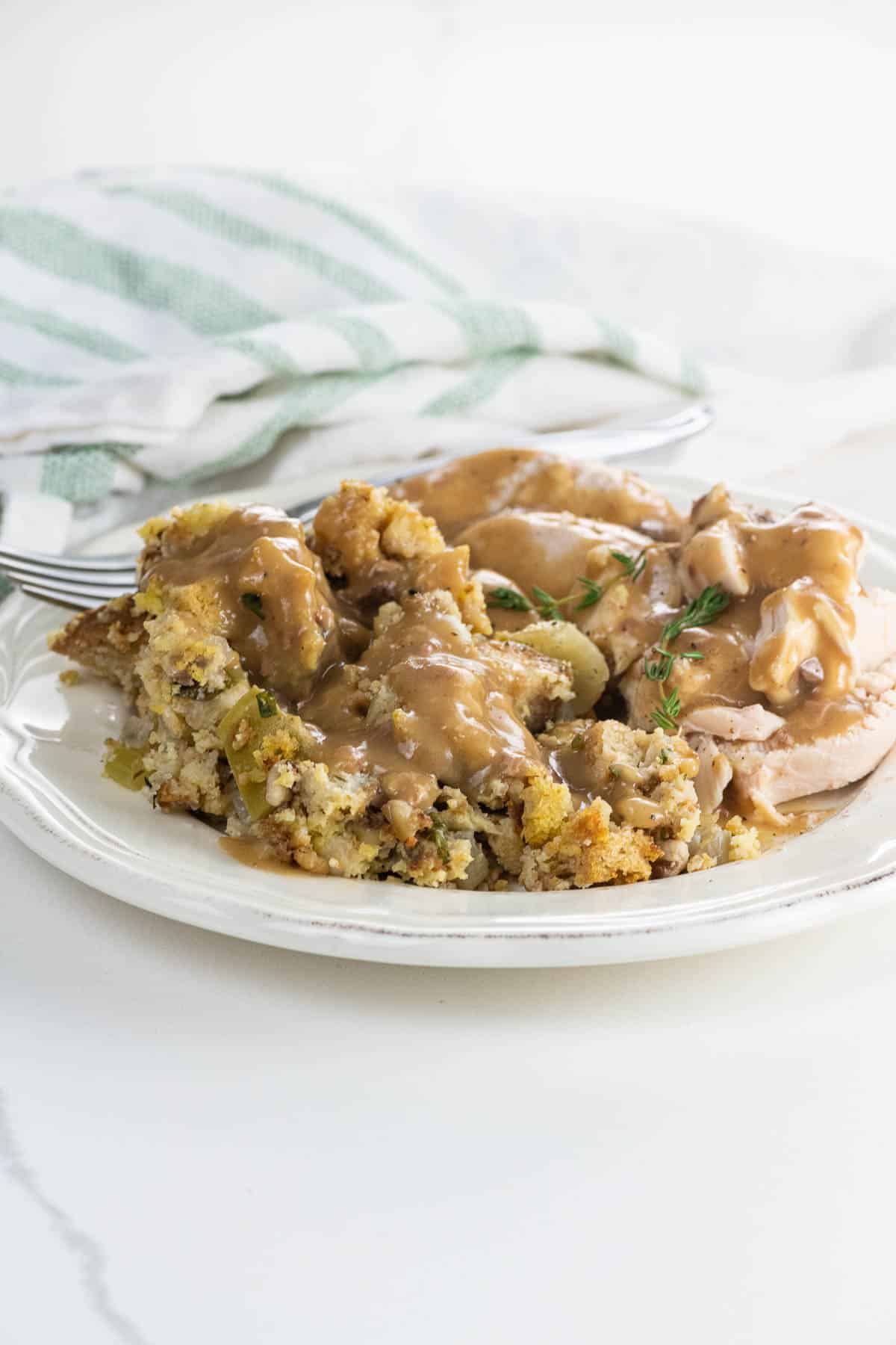 vegetarian cornbread stuffing (adapted from the silver palate) on a plate with turkey and gravy