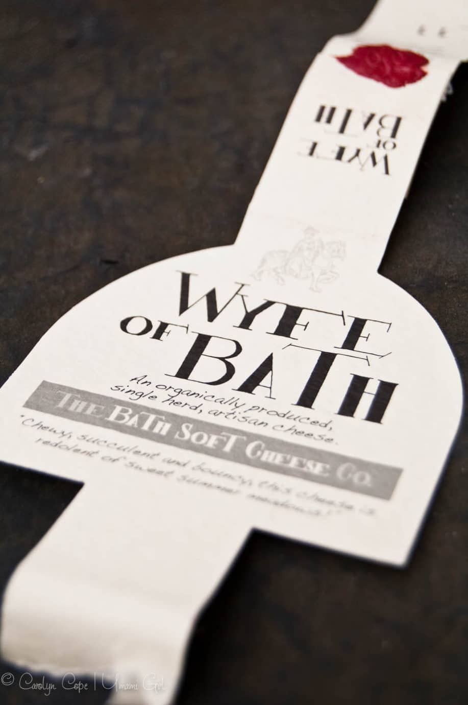 label from wyfe of bath cheese on a dark background