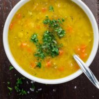 vegan split pea soup with turmeric in a bowl with a spoon