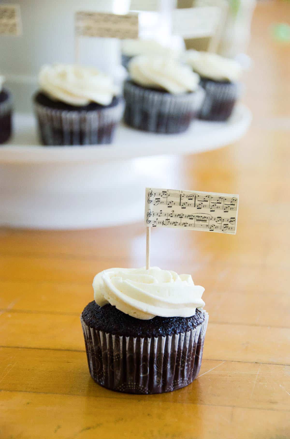 chocolate cupcakes with buttercream frosting decorated with a music theme