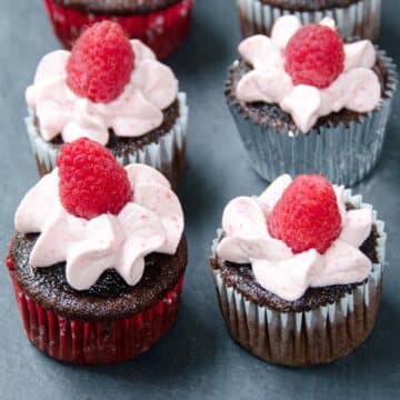 large batch chocolate cupcakes with raspberry whipped cream frosting