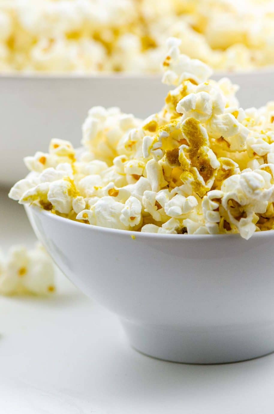 popcorn with nutritional yeast in white bowls