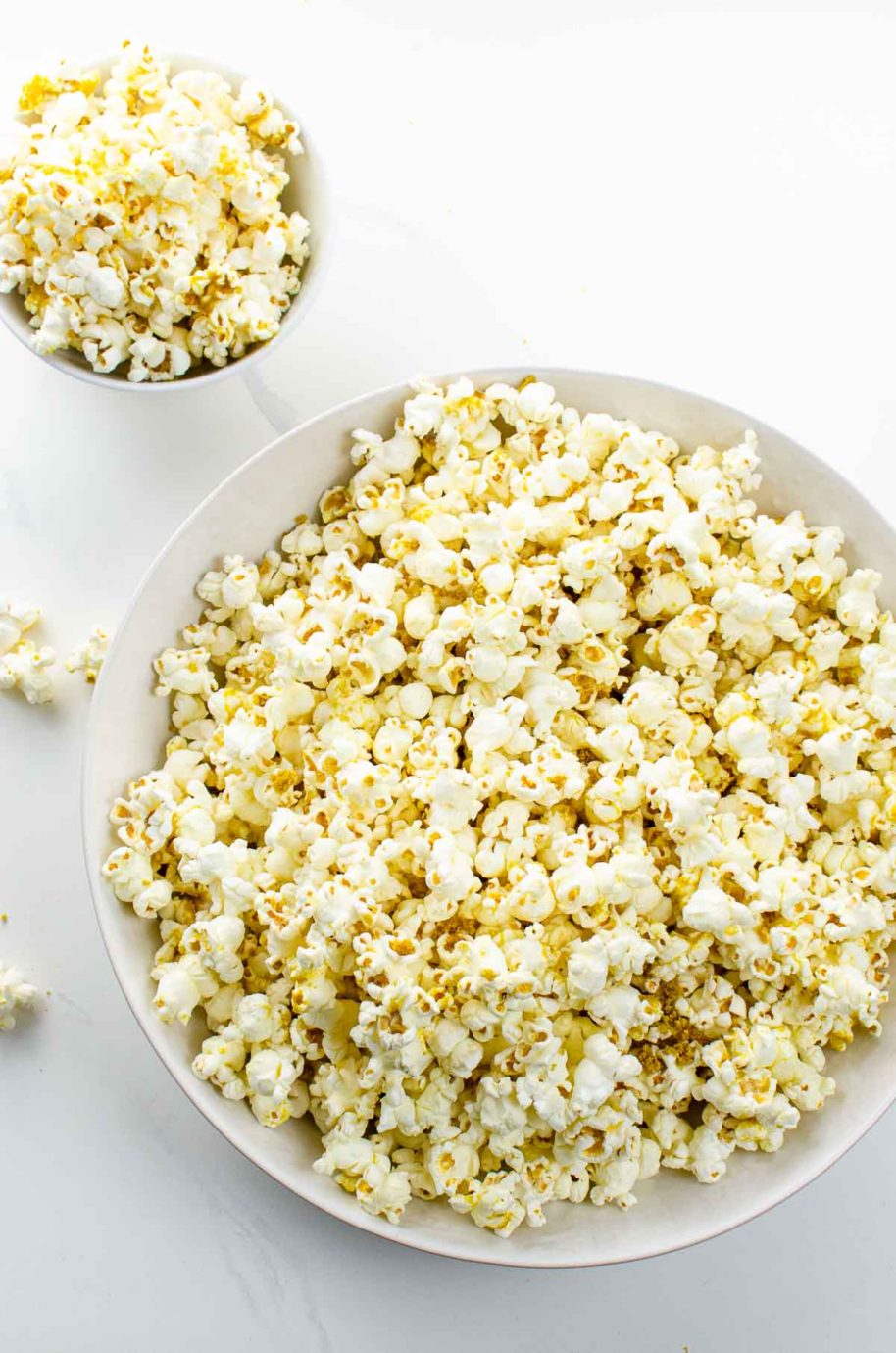 popcorn with nutritional yeast in white bowls