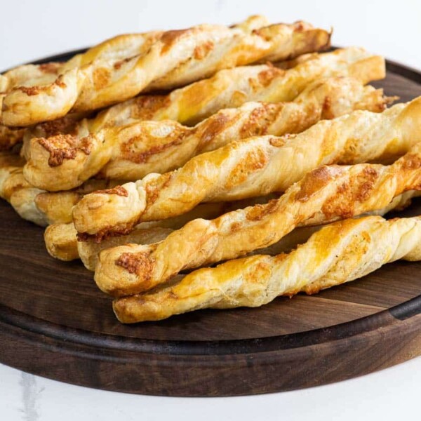 puff pastry cheese straws on a wooden board