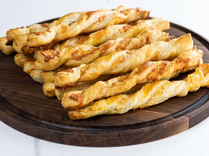 puff pastry cheese straws on a wooden board