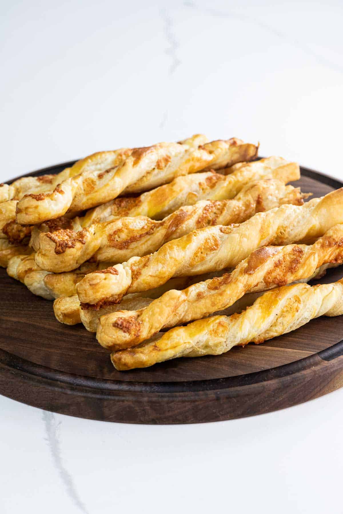 puff pastry cheese straws on a wooden board