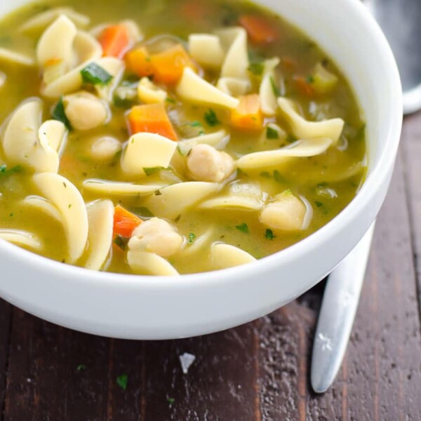 chickpea noodle soup in a bowl with a spoon