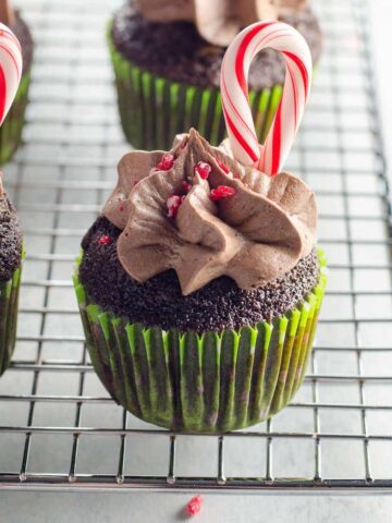chocolate candy cane cupcakes on a baking rack