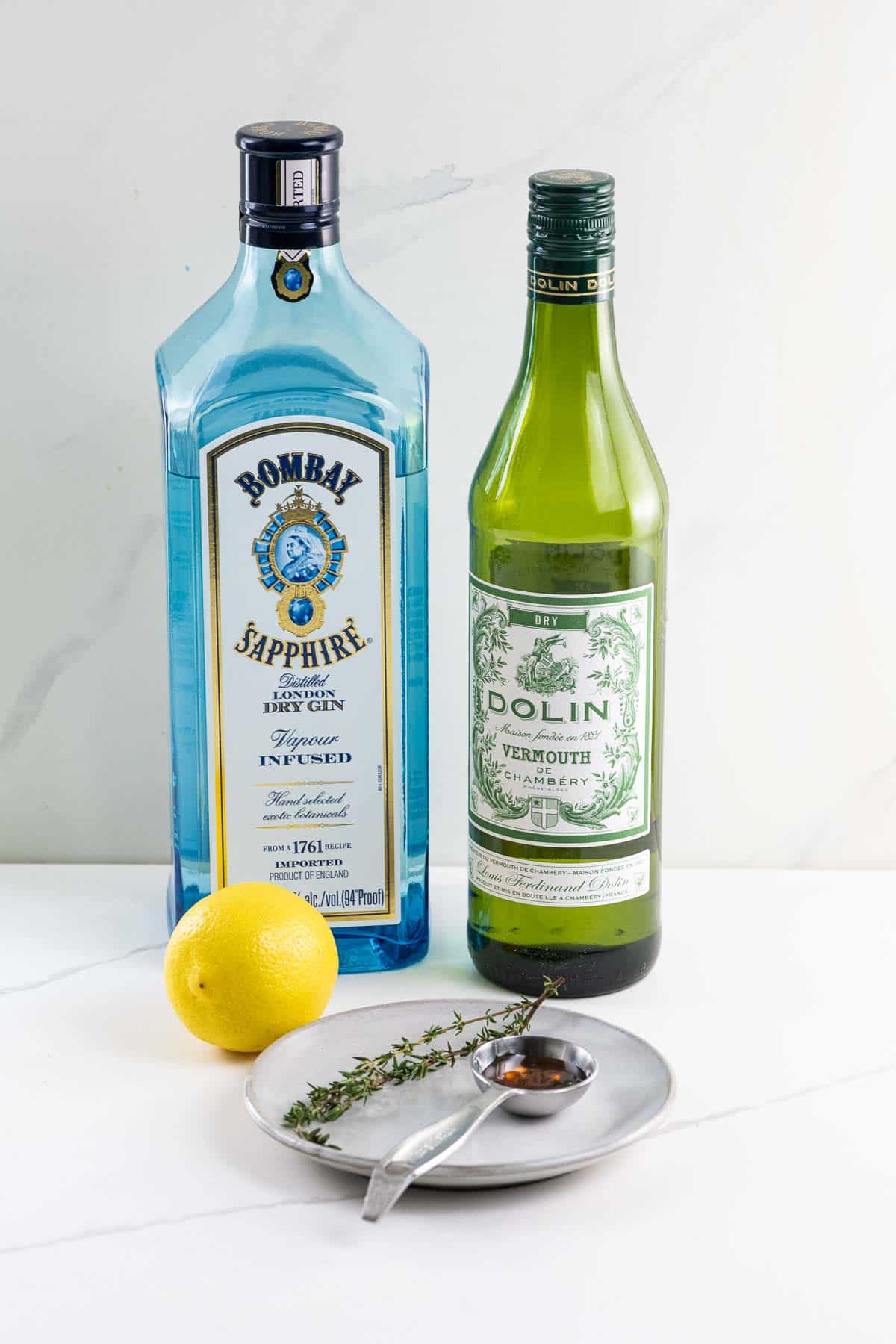 bombay sapphire gin, dolin dry vermouth, a lemon, a thyme sprig, and some honey