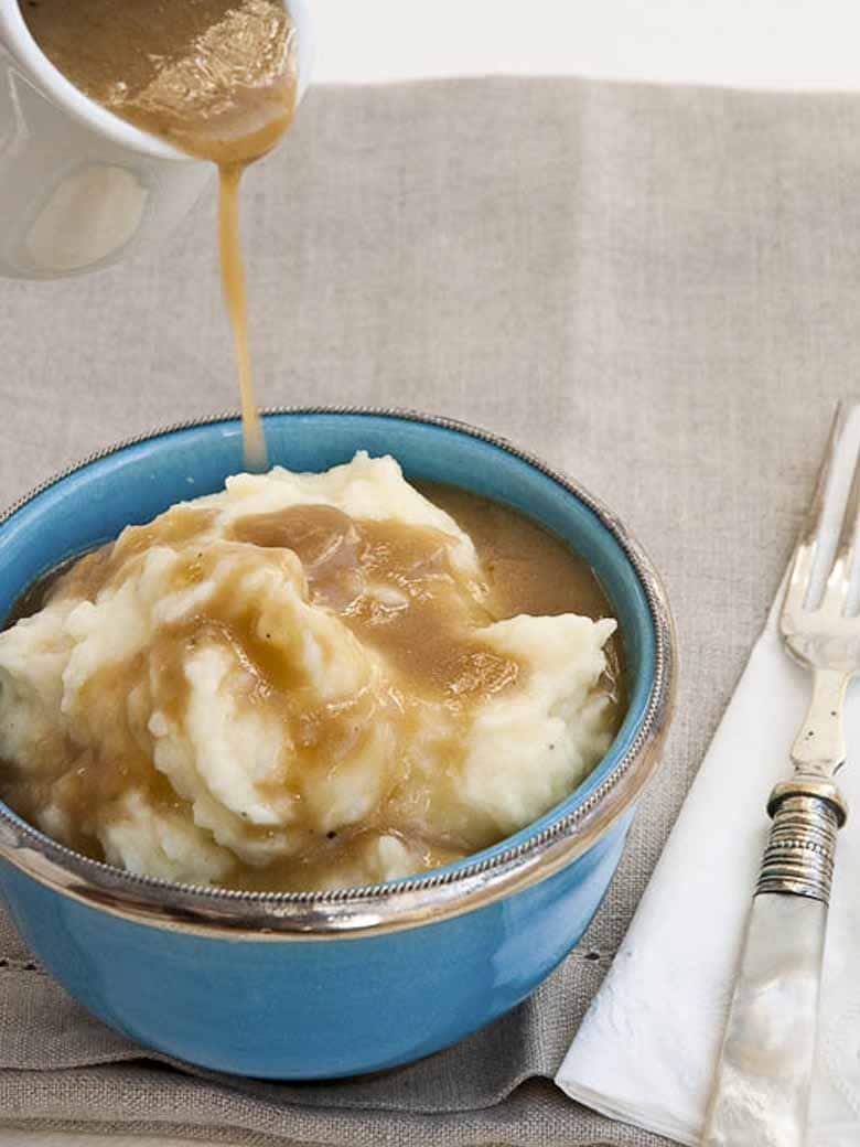 the best vegetarian gravy recipe being poured over mashed potatoes