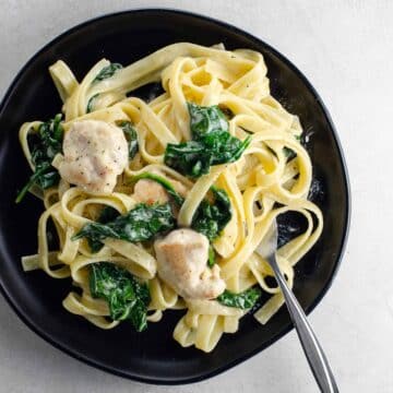 chicken alfredo with spinach on a plate