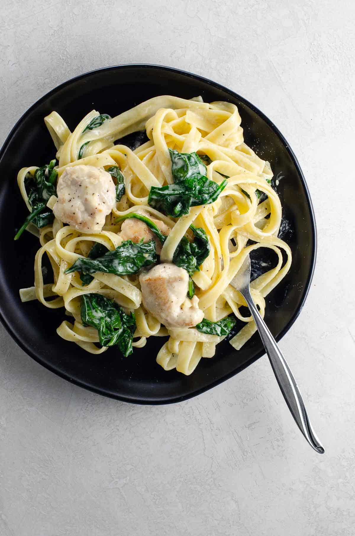 chicken alfredo with spinach on a plate
