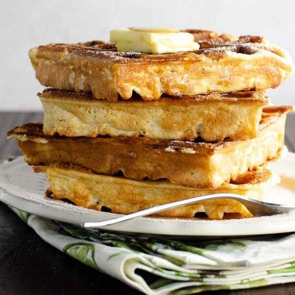 classic vanilla waffles with butter and syrup on a plate with a fork