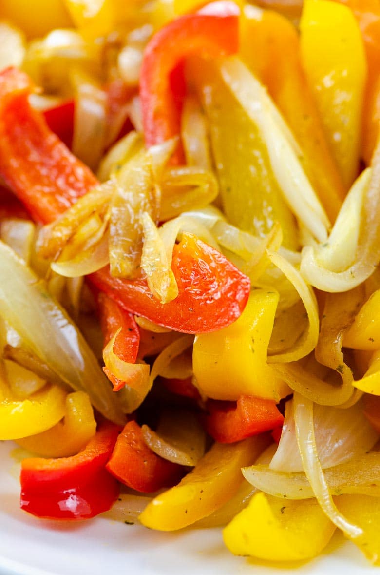 closeup of red, yellow, and orange bell peppers and onions, sautéed