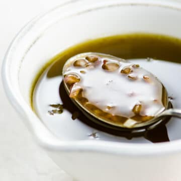 balsamic shallot vinaigrette in a small pitcher with a spoon