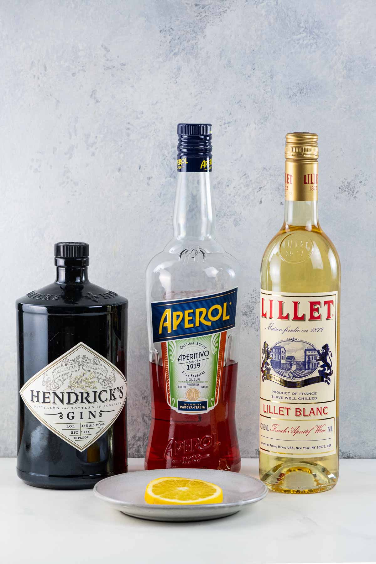 unusual negroni ingredients: hendricks gin, aperol, lillet blanc, and an orange slice