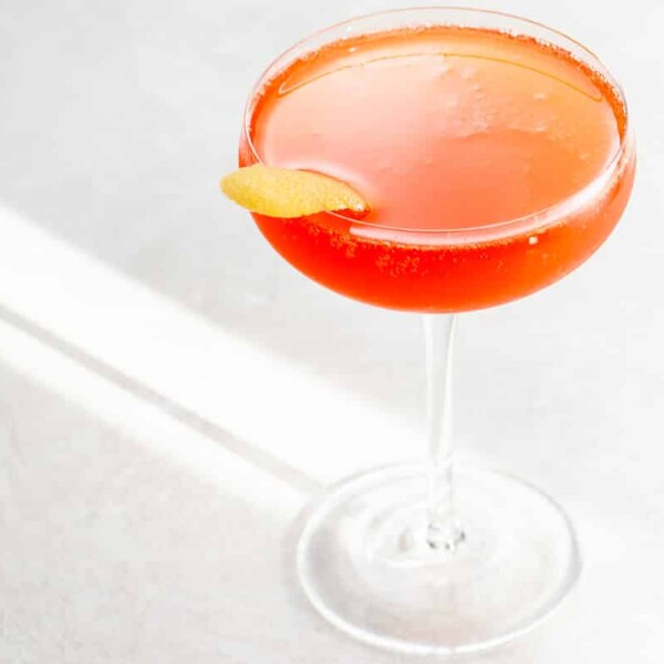 a Grape Gatsby aperol champagne verjus cocktail in a coupe glass