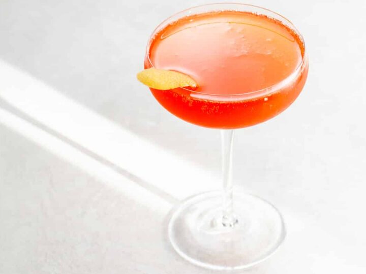 a Grape Gatsby aperol champagne verjus cocktail in a coupe glass