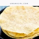 Soft Corn Tortillas stacked on a black plate