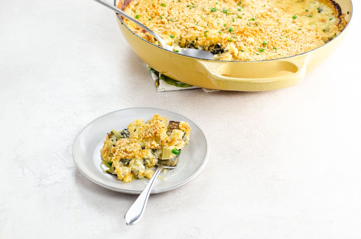 swiss chard gratin on a small plate with a fork