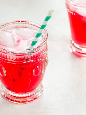 bright pink rhubarb juice in glasses with striped straws