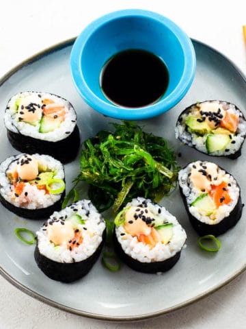 spicy salmon roll, seaweed salad, and soy sauce