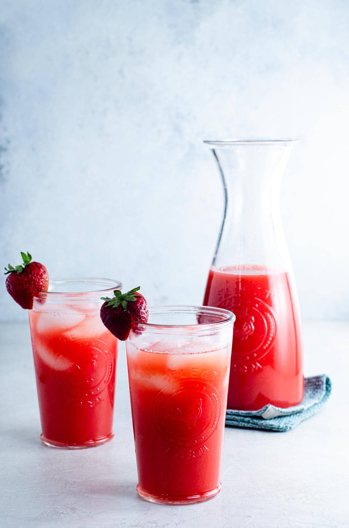 carafe and two glasses of strawberry agua fresca