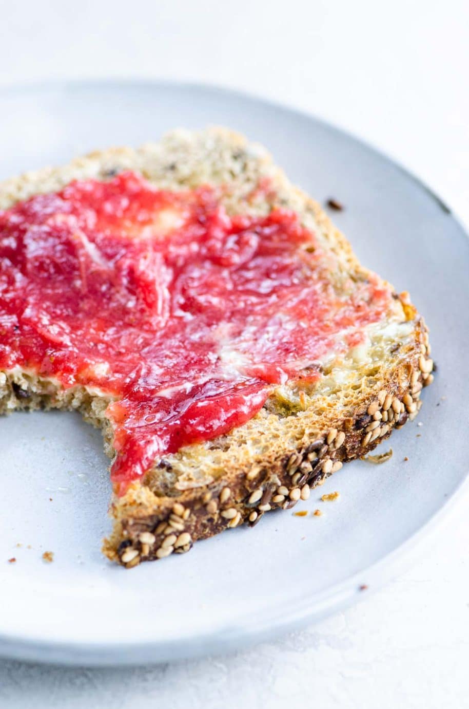 a piece of toast spread with strawberry rhubarb jam