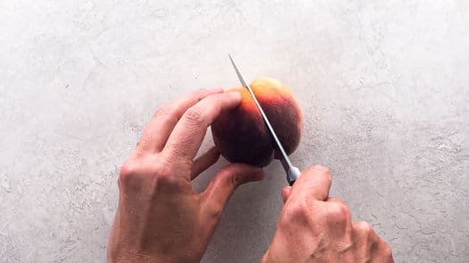 halving a peach from stem end