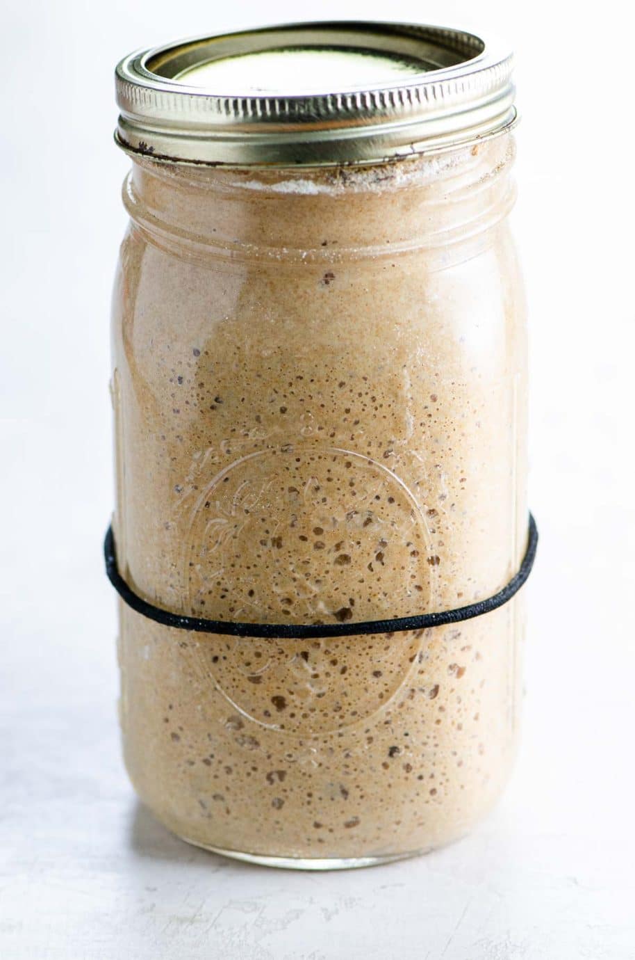 bubbly, ripe rye sourdough starter in a mason jar