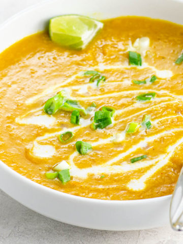 carrot and lentil soup in a white bowl