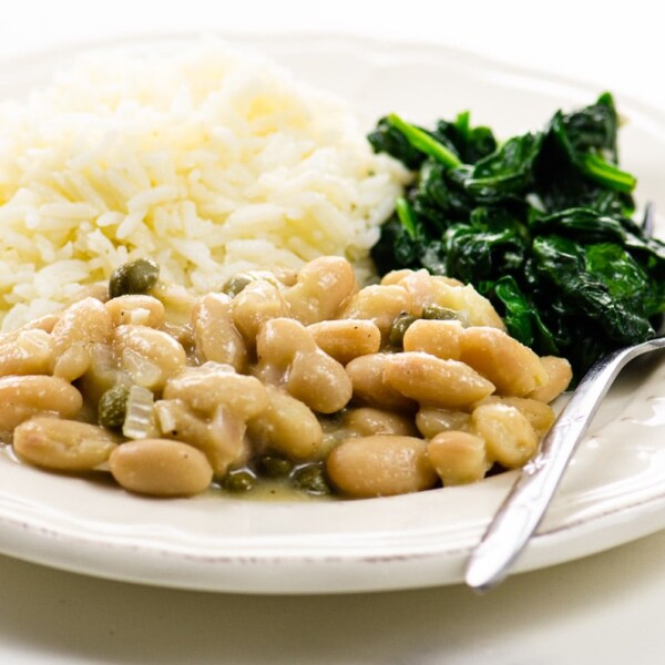 Garlicky Sauteed Spinach and Vegetarian Piccata with Cannellini Beans on a plate