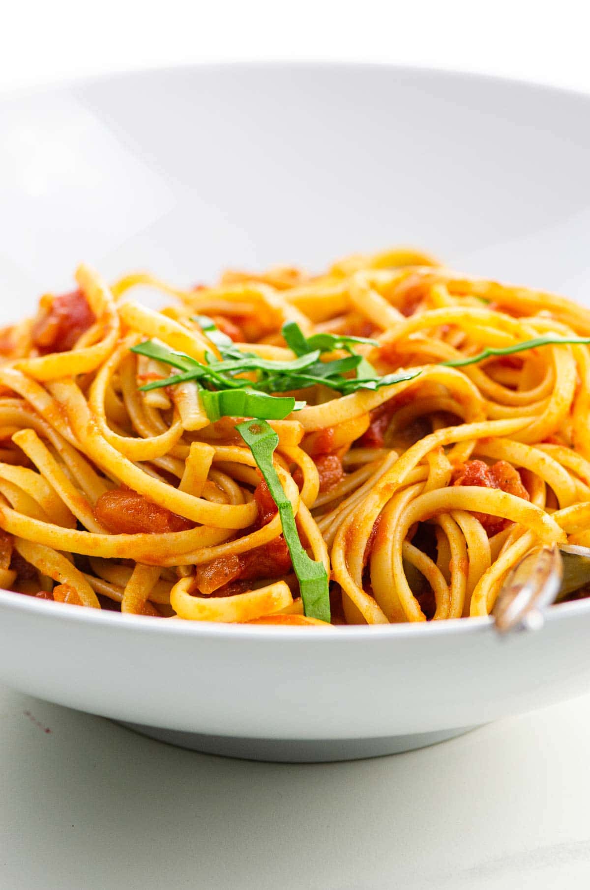 spaghetti al pomodoro in a white bowl (actually linguine)