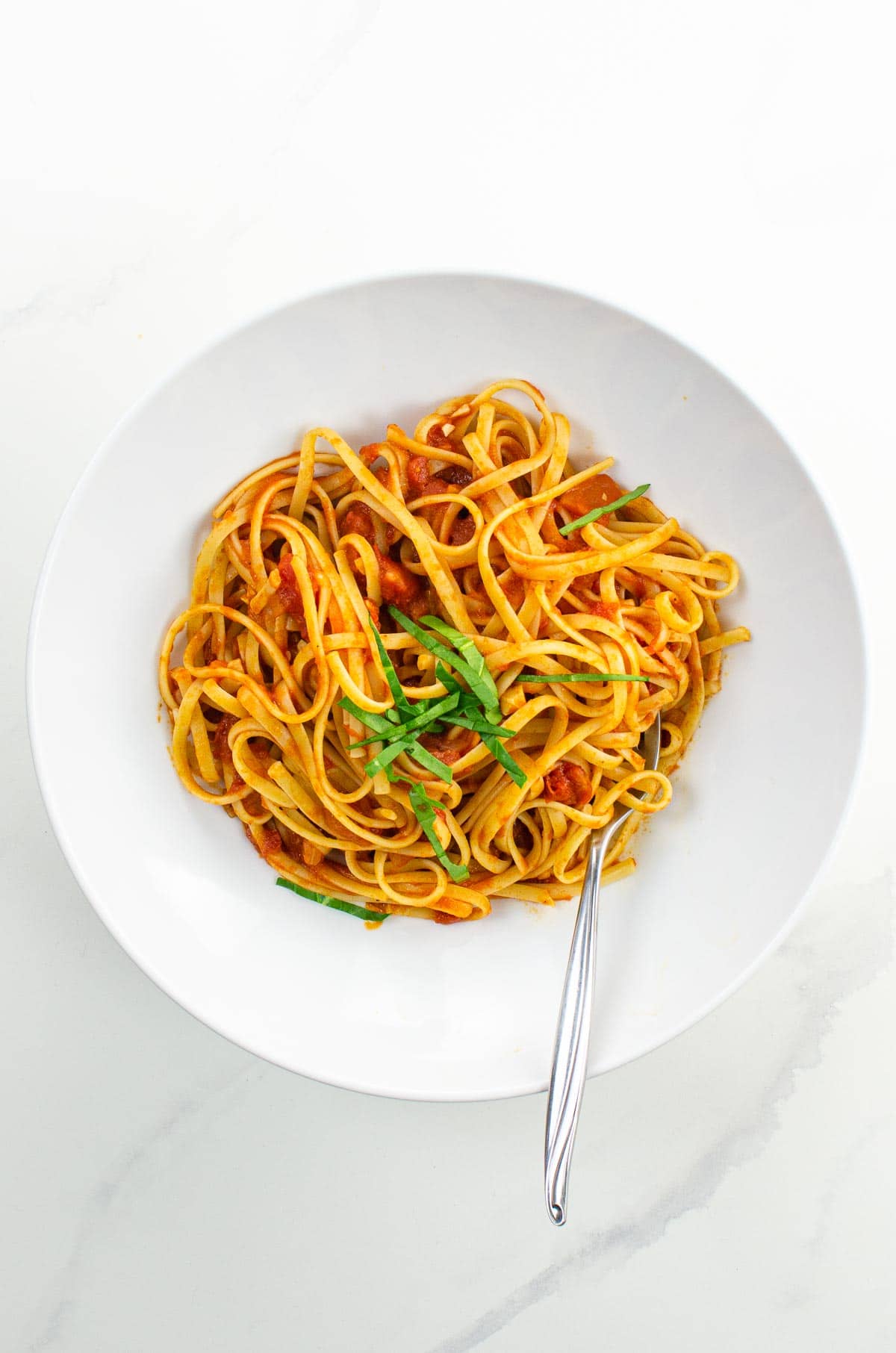 spaghetti al pomodoro in a white bowl (actually linguine)