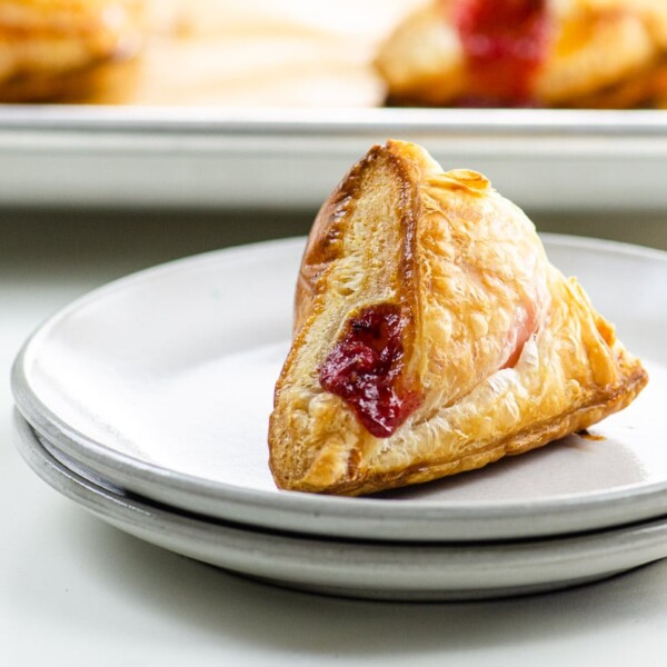 strawberry turnovers on a plate and sheet pan