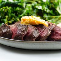 Top Sirloin Steak with Miso Butter, mashed cauliflower, and kale salad
