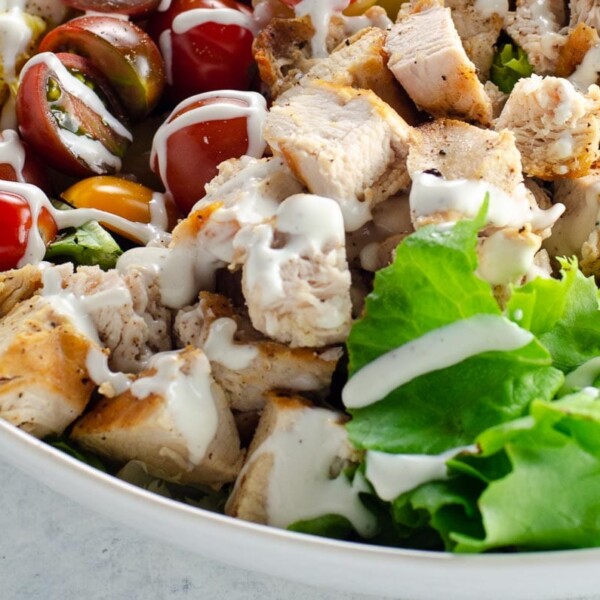 cobb salad with ranch dressing in a white bowl
