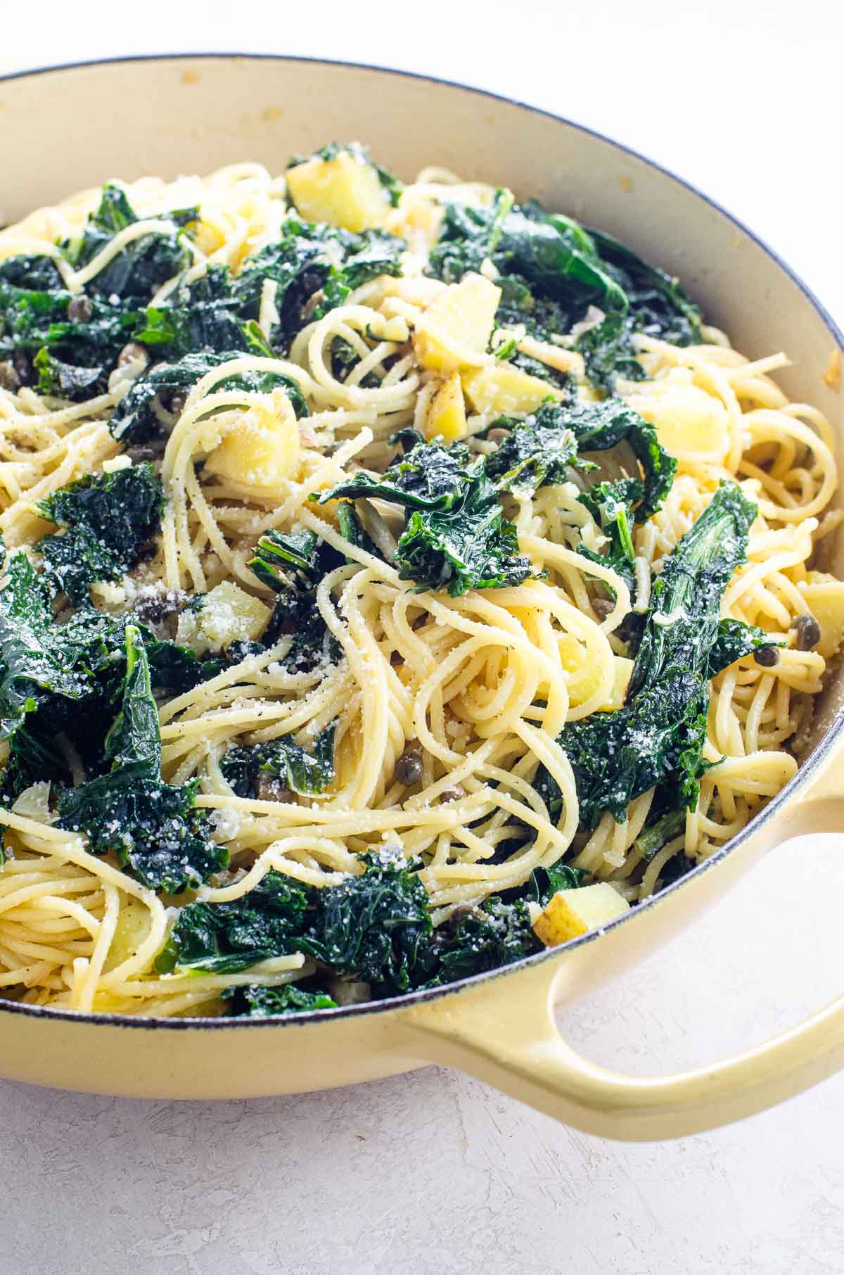 creamy kale pasta with potatoes, lemon, and capers in a pot