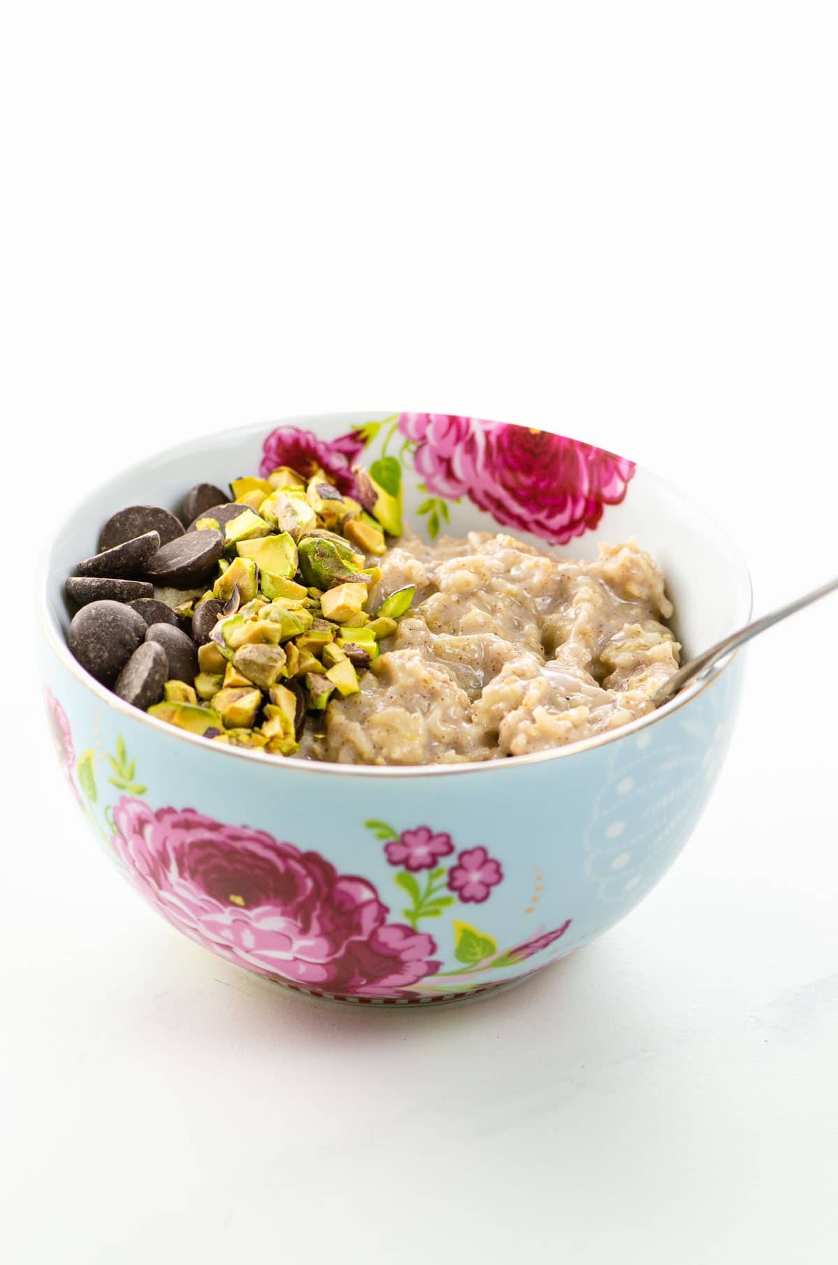 the best oatmeal recipe with chocolate chips and chopped pistachios in a pretty bowl