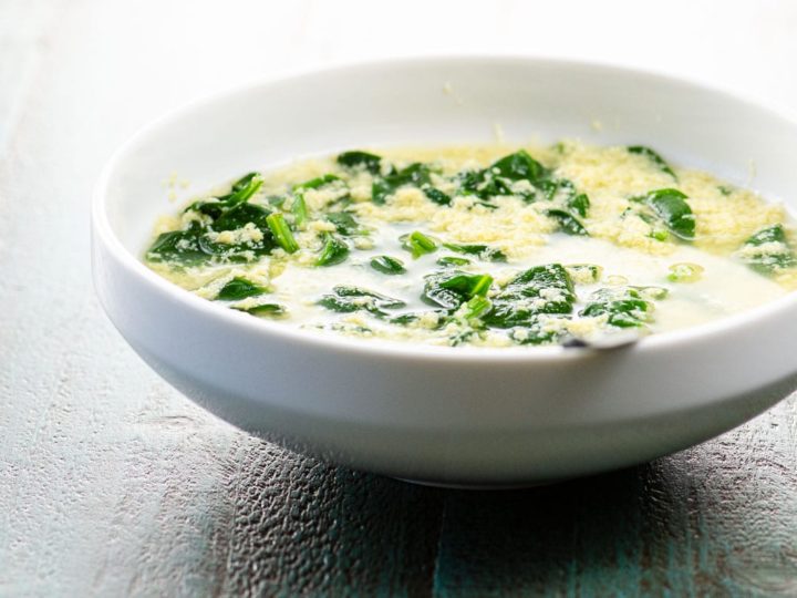 stracciatella alla romana (italian egg drop soup) in a white bowl