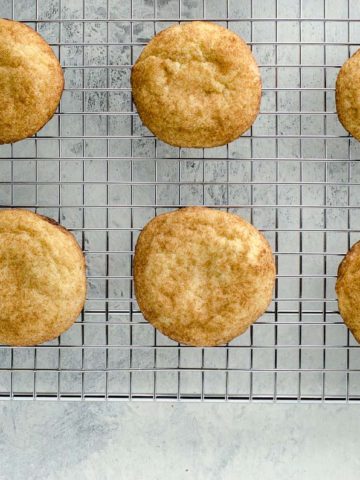 the best chewy snickerdoodles on a cooling rack