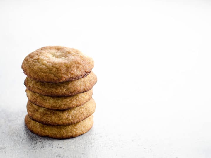 a stack of chewy snickerdoodles on a light background