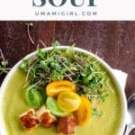 creamy asparagus ramp soup in a white bowl with halloumi, tomato, and microgreen garnish