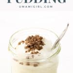 classic vanilla pudding with whipped cream and chocolate shavings in a jam jar with a spoon