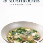 miso soup with mushrooms and spinach in a bowl with a spoon