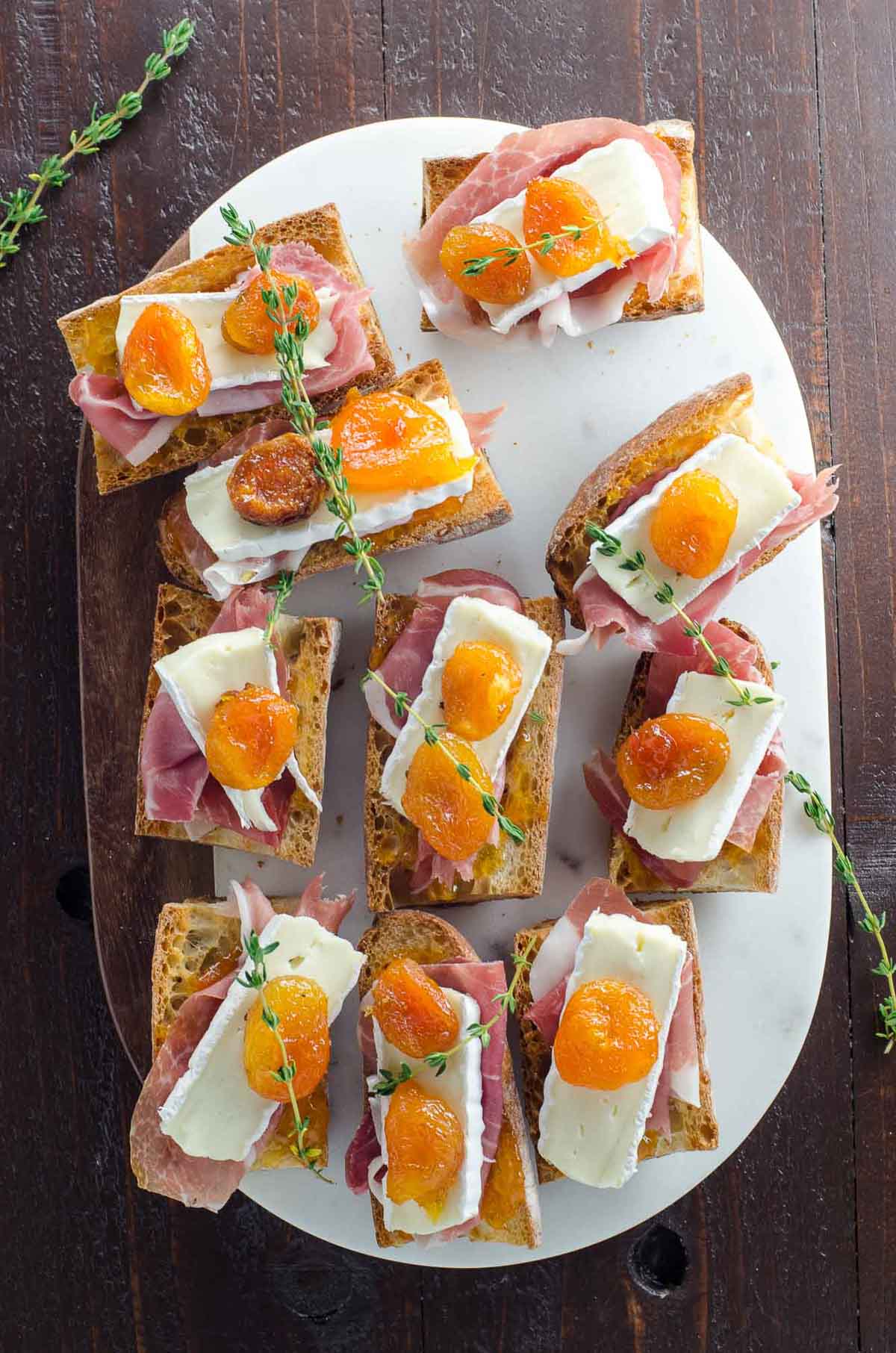baguette pieces toasted and layered with prosciutto, brie, apricots, and thyme