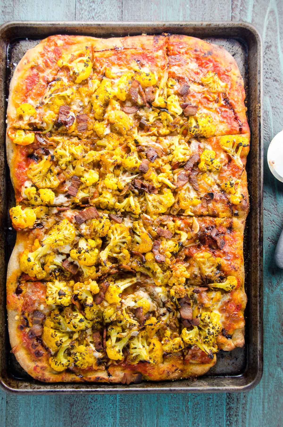 pizza amatriciana with cauliflower on a sheet pan