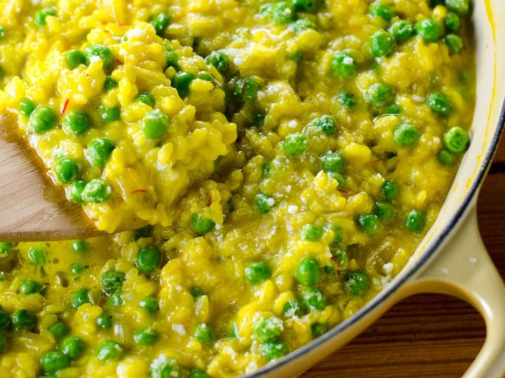 saffron risotto with goat cheese and peas in a pan