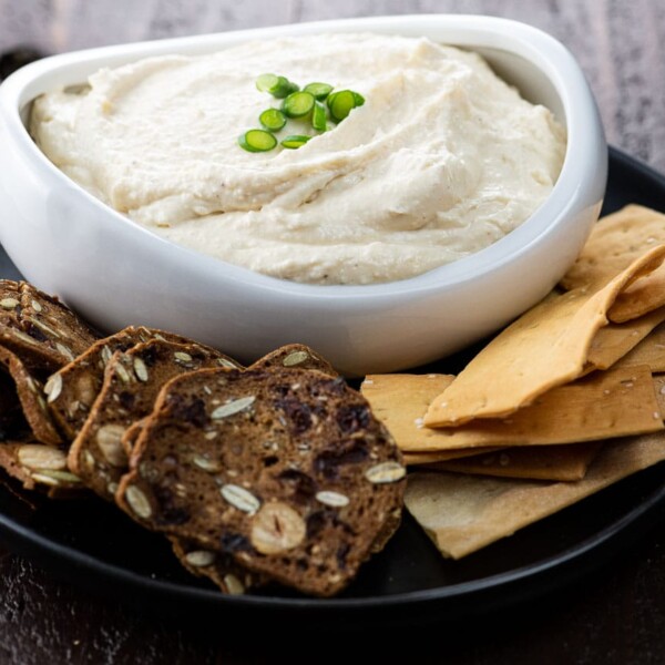 pub cheese in a white bowl with two kinds of crackers